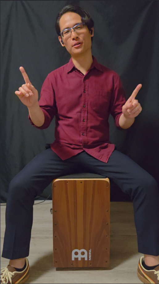 Reuben sitting on a cajon, ready to teach